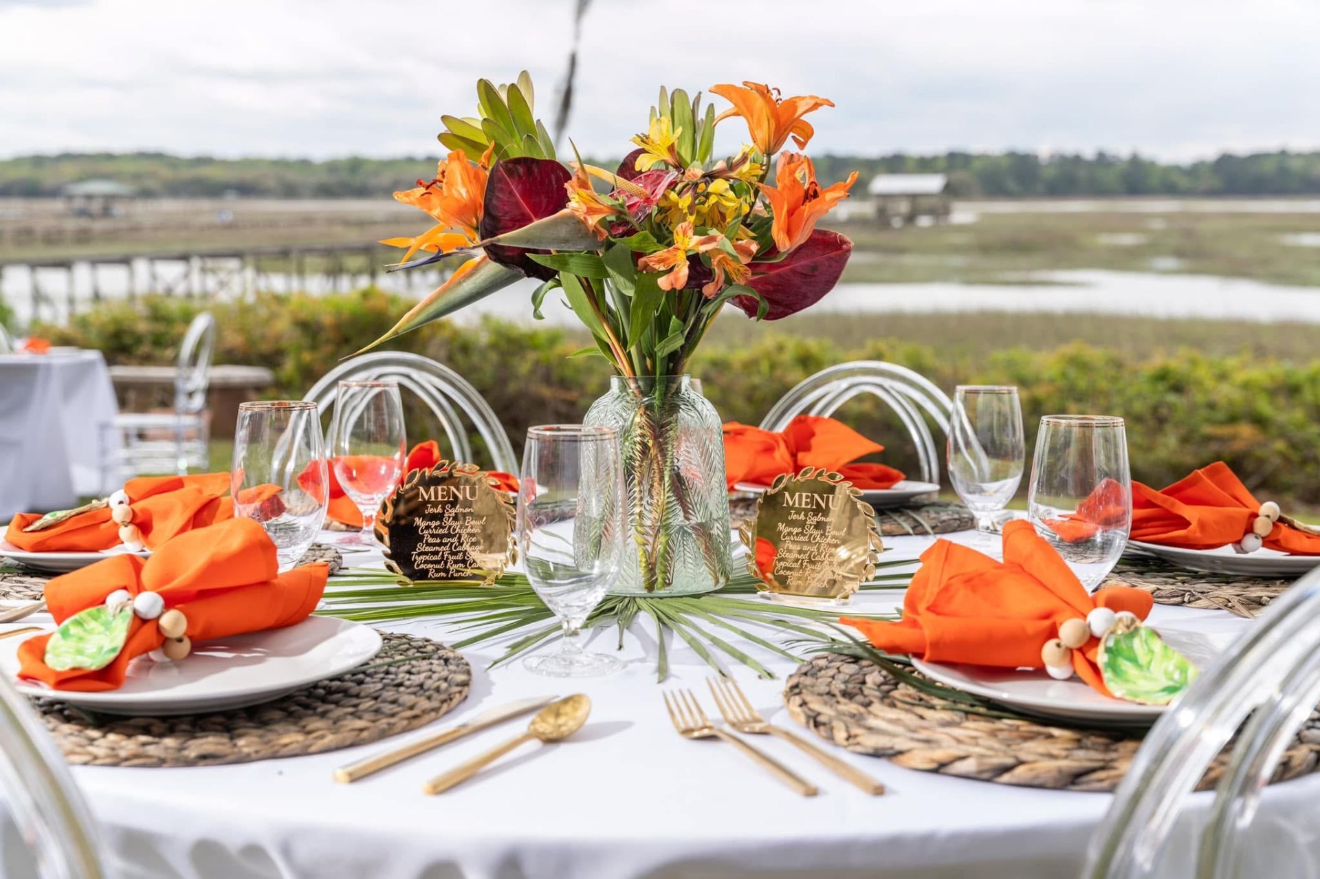 Lowcountry tablescape with tropical florals and gold flatware